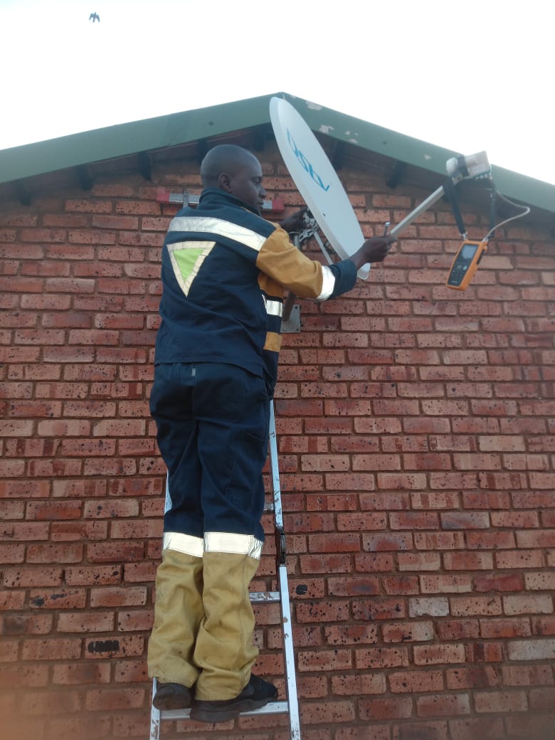 Technician installing exterior electrical or signal equipment