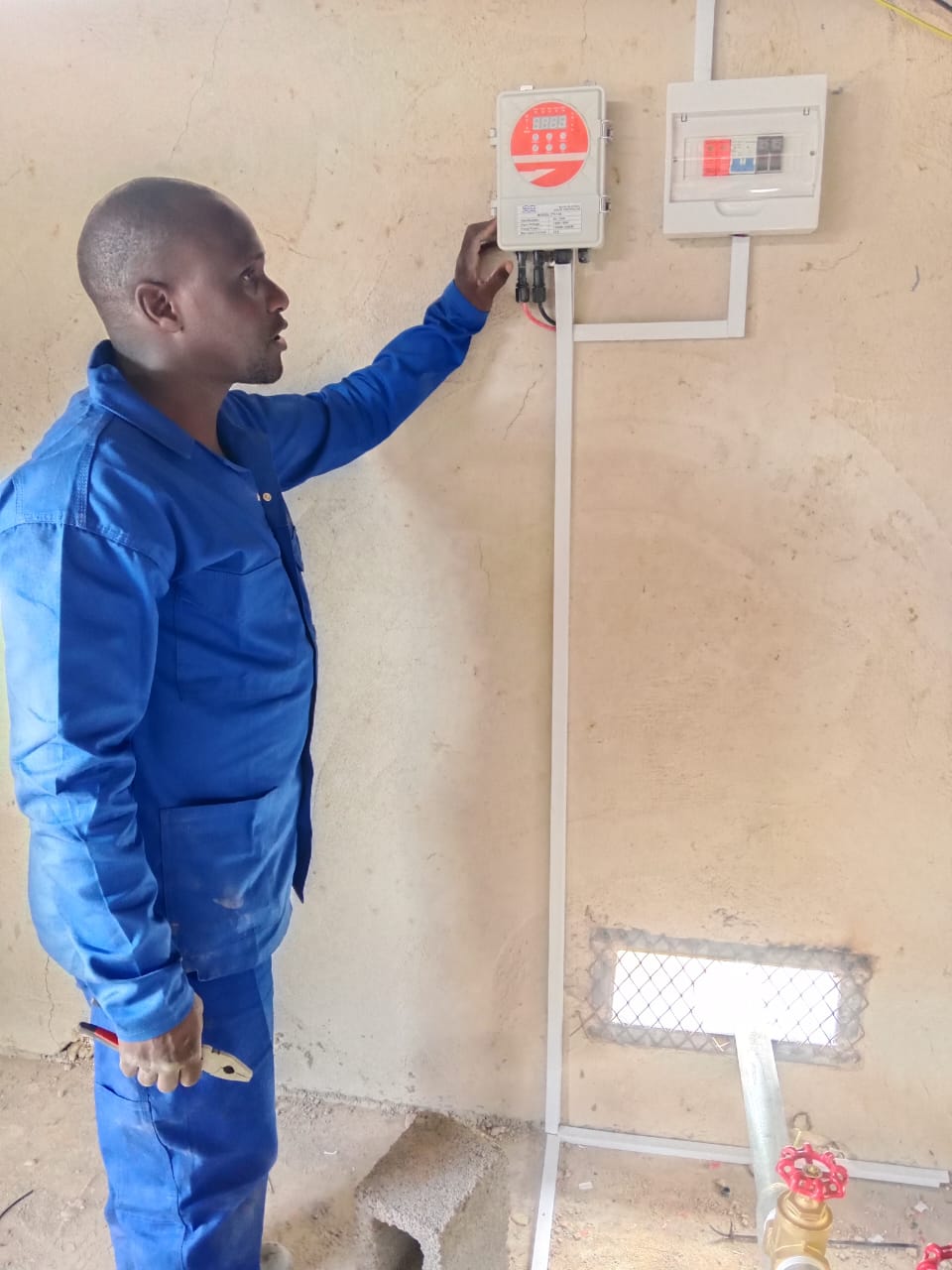 Technician explaining installed electrical controls to a client