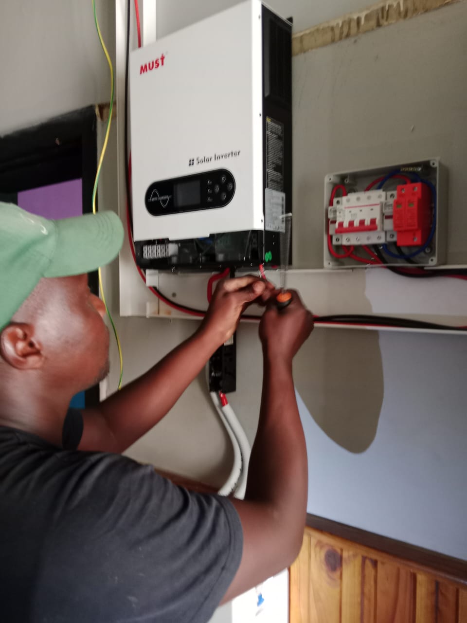 Technician completing inverter connection and testing